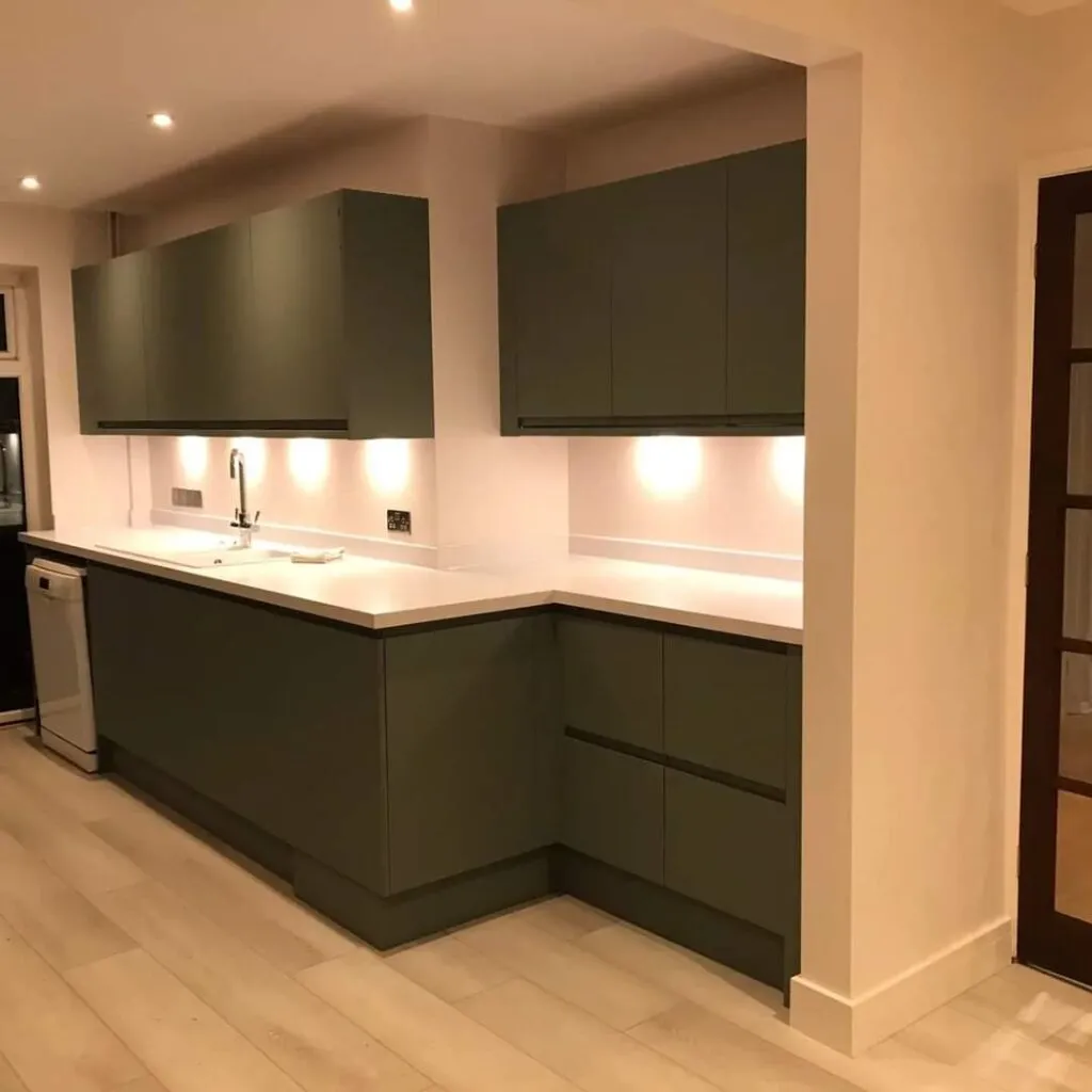A kitchen with a sink, dishwasher and cabinets.